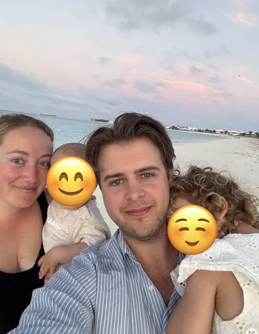 Nick and Simona Perry on a beach with their two children